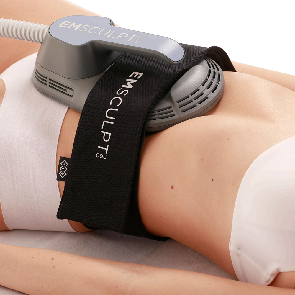 woman laying down with emsculpt neo device on her stomach