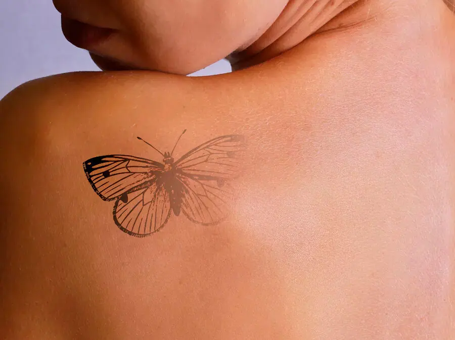 image of a faded butterfly tattoo on a woman's shoulder