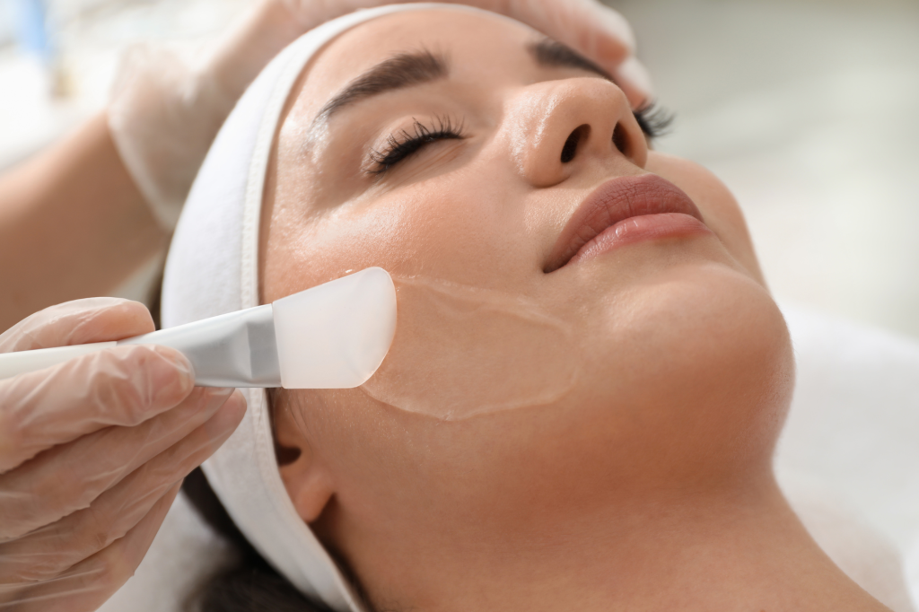 Woman getting a facial with a peel being applied to her face