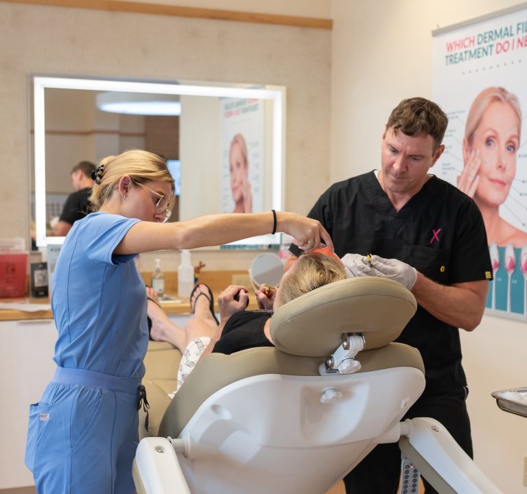dr.tichy and nurse giving an botox injections to client