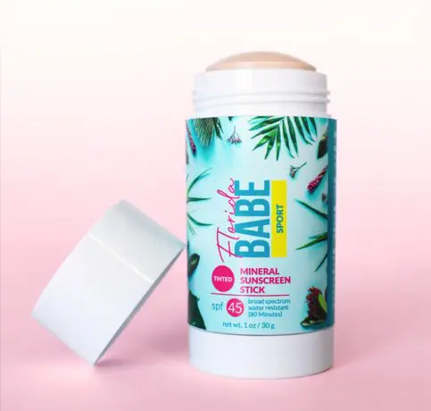 product photo of florida babe sunscreen stick with a pink background